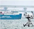  ??  ?? A vessel passes under the Crimea Bridge that joins mainland Russia to the peninsula