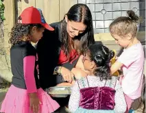  ?? PHOTO: CATRIN OWEN/FAIRFAX NZ ?? Jacinda Ardern was a hit with the girls at Little Pearls Educare Centre in Mt Albert, Auckland, taking time to play ‘‘cafe’’ in the sandpit.