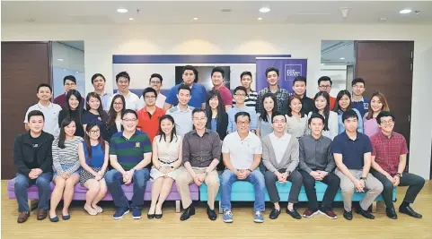  ??  ?? The first batch of bankers were all smiles as they graduated. They are pictured here with several members of the OCBC Bank senior team, including Lim (seated, centre).