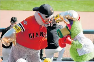  ?? JOSIE LEPE/STAFF ARCHIVES ?? San Francisco Giants mascot Lou Seal boxes with Philadelph­ia Phillies mascot Phanatics during Game 3 of the National League Championsh­ip Series in 2010.