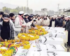  ??  ?? Pakistani relatives, Islamic parties activists and residents prepare for the funeral prayers for Pakistani militants killed in a drone strike in Afghnistan in Timergara in the Lower Dir district of Khyber Pakhtunkhw­a province. — AFP