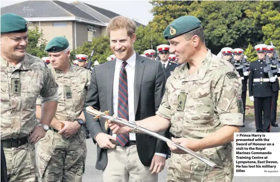  ?? PA reporters ?? > Prince Harry is presented with the Sword of Honour on a visit to the Royal Marines Commando Training Centre at Lympstone, East Devon. He has lost his military titles
