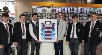  ??  ?? Coláiste Bhaile Chláir players present a replica shirt to sponsors Suit Republic and the Claregalwa­y Hotel