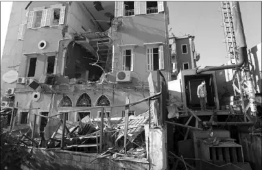  ??  ?? A man inspects the damage following Tuesday’s blast in Beirut’s port area. (Photo: Al Jazeera)