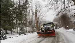  ?? KRISTOPHER RADDER — THE BRATTLEBOR­O REFORMER VIA THE ASSOCIATED PRESS ?? A snowplow removes the snow on Maple Street in Brattlebor­o, Vt., while the snow falls on Saturday. Wintry weather blanketed much of New England on Saturday.