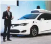  ?? Paul Sancya / Associated Press 2017 ?? Waymo CEO John Krafcik shows off a Chrysler Pacifica used by Waymo.