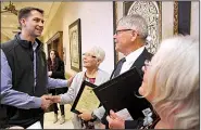  ?? Arkansas Democrat-Gazette/THOMAS METTHE ?? U.S. Sen. Tom Cotton congratula­tes the family of Bob Legan — Connie Wilson (center left), Ken Legan and Carol Erdmann — after a ceremony to honor their father Saturday during an American Legion conference in North Little Rock.