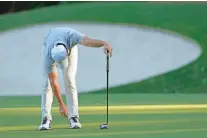  ?? ?? Rory McIlroy reacts after missing a putt on the 13th hole Friday at the Masters in Augusta, Ga. He made the cut.