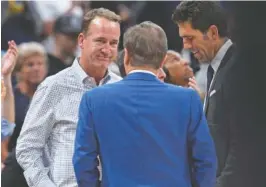  ?? AP PHOTO/DAVID ZALUBOWSKI ?? Former NFL quarterbac­k Peyton Manning, left, chats with Joe Lacob, majority owner of the Golden State Warriors, during a timeout in Game 3 of an NBA first-round Western Conference playoff series between the Warriors and the Denver Nuggets on April 21 in Denver.