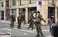  ?? AP/SEBASTIEN EROME ?? French anti-terrorism soldiers secure the site of an explosion Friday in Lyon. The anti-terrorism agency is investigat­ing the blast.