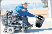  ??  ?? Alicia Contreras of Oakland picks up trash at Middle Harbor Shoreline Park. She joined nearly 100 people at the park.