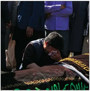  ?? (AP/Mariam Zuhaib) ?? A man cries Sunday in a cemetery near Kabul as Afghans bury the victims of a bombing at a girls school. In the aftermath of Saturday’s attack, the Afghan government drew criticism from grieving family members who said the nation’s leaders have failed to protect them. More photos at arkansason­line.com/510kabul/.