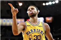  ?? AP Photo/Ben Margot ?? ■ Golden State Warriors’ Stephen Curry celebrates a score against the Washington Wizards during the second half Wednesday in Oakland, Calif.