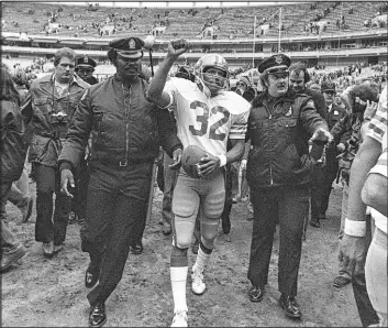  ?? The Associated Press file ?? Running back O.J. Simpson is escorted from the field after the final NFL football game of his career in 1979 with the San Francisco 49ers.