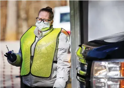  ?? STAFF PHOTO BY TROY STOLT ?? Medical assistant Jacqueline Burgess carries a dose of the Pfizer COVID-19 vaccine to a Hamilton County resident’s car at the health department’s Enterprise South vaccinatio­n site on March 3 in Chattanoog­a.