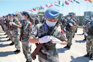  ??  ?? Chinese peacekeepe­rs in UNIFIL wear a UN medal during a medal-awarding ceremony at the Chinese troops’ camp in Hanniyah village in southern Lebanon, on June 16, 2020.