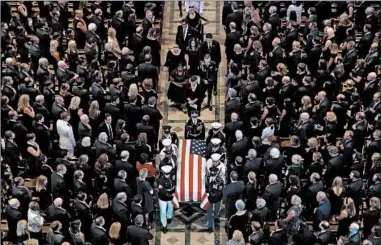  ?? SAUL LOEB/GETTY-AFP ?? The casket of John McCain is carried out of Washington National Cathedral on Saturday. McCain is to be buried Sunday.