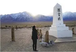  ?? BRIAN MELLEY AP FILE ?? Lori Matsumura visits the cemetery at the Manzanar National Historic Site near Independen­ce. It was one of the World War II-era Japanese internment camps.