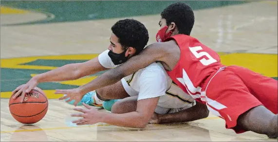  ?? DANA JENSEN/THE DAY ?? New London’s Anthony Martinez, left, and NFA’s Tyler Spruill battle for a loose ball during the Whalers’ 57-54 opening night win on Friday night at Conway Gymn.