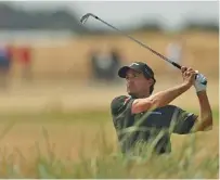  ?? THE ASSOCIATED PRESS ?? Kevin Kisner plays out of the rough on the 18th hole during the first round of the British Open Championsh­ip in Carnoustie, Scotland, on Thursday. Kisner’s 66 held up for the tournament lead.