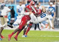  ??  ?? Florida Atlantic’s James Pierre puts a big hit on Middle Tennessee State quarterbac­k Asher O’Hara during the first half.