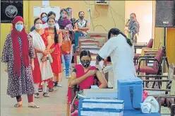  ??  ?? A health worker administer­s the Covid-19 vaccine to a woman in Bengaluru on Monday.
