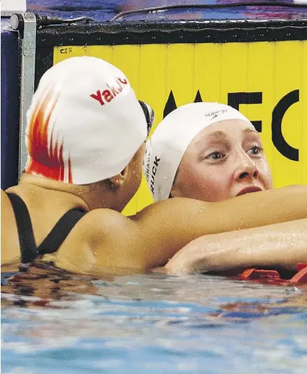  ?? JASON FRANSON /THE CANADIAN PRESS ?? Taylor Ruck, right, is congratula­ted after winning the 200-metre freestyle race during Wednesday’s action at the Canadian Swimming trials at the Kinsmen Sports Centre.