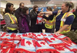  ?? CP FILE PHOTO ?? Syrians refugees admitted to Canada under the government’s landmark resettleme­nt program are seen in this December 2015 file photo.