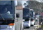  ?? JOSE CARLOS FAJARDO — STAFF PHOTOGRAPH­ER ?? Three buses exit Travis Air Force Base in Fairfield on Monday. A quarantine was lifted for about 140former cruise ship passengers.