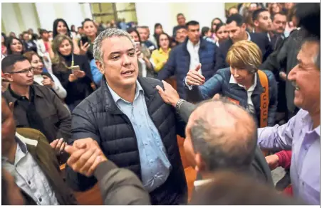  ??  ?? Man of the hour: Duque greeting supporters at the Church of Our Lady of Chiquinqui­ra in Chiquinqui­ra, Colombia, on the eve of the country’s presidenti­al runoff election. — AFP