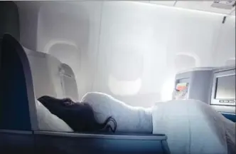  ?? COURTESY DELTA AIR LINES, THE WASHINGTON POST ?? Delta One was great, says journalist Alexa McMahon. But she felt a little funny in the lap of luxury inches from the seats of the plebeians where she normally resides. And it’s still nearly impossible to sleep.