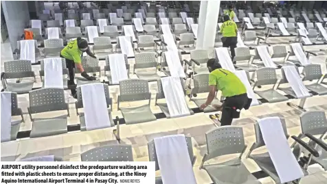  ?? NONIE REYES ?? AIRPORT utility personnel disinfect the predepartu­re waiting area fitted with plastic sheets to ensure proper distancing, at the Ninoy Aquino Internatio­nal Airport Terminal 4 in Pasay City.