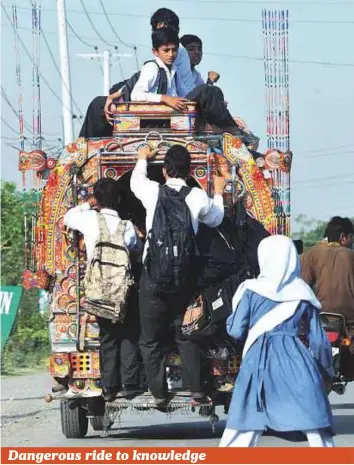  ?? APP ?? Students travelling to school on a converted pick-up hang on for dear life. Every such ride is an accident waiting to happen in Pakistan.