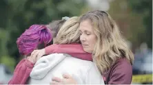  ?? ANDREW STEIN, PITTSBURGH POST-GAZETTE, AP ?? Cody Murphy, 17, left, Sabrina Weihrauch and Amanda Godley, all of Pittsburgh, hug after the attack.