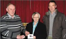  ??  ?? Jim Quane of Dromina Coursing Club making a presentati­on to Dora O’Sullivan with Donal O’Connell, who was the MC for the evening, to mark her retirement as sacristan of the local church.