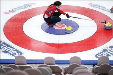  ?? The Associated Press ?? Team Wild Card 3 skip Beth Peterson lines up a shot in front of cardboard fan cutouts at the Scotties Tournament of Hearts in Calgary on Saturday.