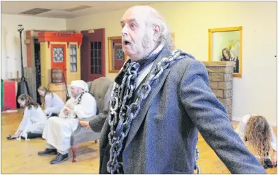  ?? MILLICENT MCKAY/JOURNAL PIONEER ?? Peter Surkan, centre, donned his chains as Jacob Marley during a rehearsal of the song “Link by Link” for the upcoming Fandango Musical Production­s Inc. musical “A Christmas Carol.”