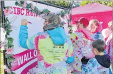  ?? SUBMITTED PHOTO ?? Brenda’s Breast Buddies sign the wall of hope at the 2017 CIBC Run for Cure in Trenton.