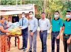  ?? ?? Ampara, distributi­ng dry rations with the presence of Administra­tive officer