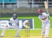  ?? AFP PHOTO ?? West Indies’ Shane Dowrich (right) scored a hundred on the second day to help the hosts get past 400.