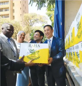  ?? — Picture by Memory Mangombe ?? Local Government, Public Works and National Housing Minister July Moyo (left) and his deputy Jennifer Mhlanga (second from left) receives cooking oil donation from Indian Ambassador to Zimbabwe Mr Rungsung Masakui (right) and Cangrow Private Limited Director Ankit Jain (second from right) during the second round of donations to Cyclone Idai victims by the Indian business community in Zimbabwe, in Harare yesterday.