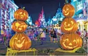  ?? WALT DISNEY CO. ?? Stacks of jack-o’-lanterns frame Cinderella Castle on Main Street, U.S.A., in the Magic Kingdom as decoration­s set the stage for Mickey’s Not-So-Scary Halloween Party. This year’s event has been canceled.