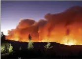  ?? NOAH BERGER — THE ASSOCIATED PRESS FILE ?? In this photo, taken with a long camera exposure, the Caldor Fire burns in Eldorado National Forest.