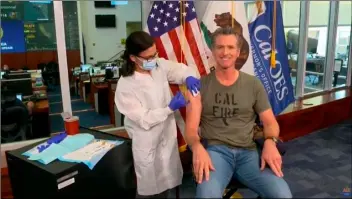  ?? CALIFORNIA GOVERNOR’S OFFICE VIA AP ?? In this image taken from live streamed video from the California Governor’s Office, California Gov. Gavin Newsom getting a flu shot during a news conference on Monday in Rancho Cordova, Calif.