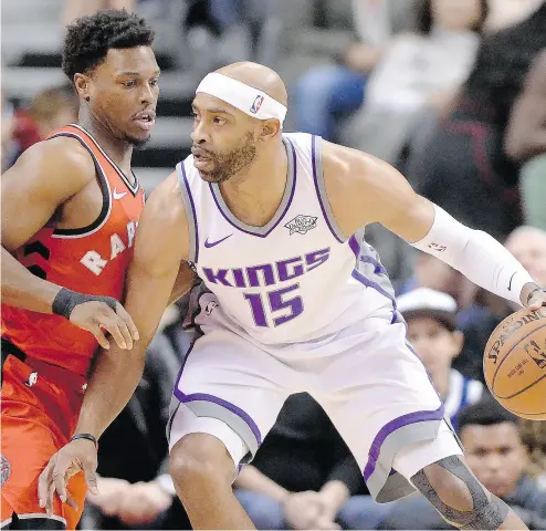 ?? FRANK GUNN / THE CANADIAN PRESS ?? Sacramento Kings guard Vince Carter, formerly the face of the Toronto Raptors’ franchise, looks to make a move around Kyle Lowry during NBA action on Sunday at the ACC. The Raptors spoiled Carter’s return with a 108-93 win.