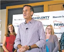 ?? GLEN STUBBE/STAR TRIBUNE VIA AP ?? Tim Pawlenty stands with his wife, Mary, left, and running mate Michelle Fischbach as he concedes his run for governor Tuesday at Granite City Food and Brewery in Eagan, Minn. The ranks of forgotten Republican­s are growing. Some were forced out, such as Pawlenty, a former two-term Minnesota governor who lost his bid for a political comeback.