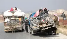 ?? AFP ?? Displaced families from an Idlib village head for the northern part of the rebel-held province yesterday