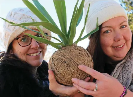  ??  ?? GARDENING TREND: Kylie Campbell (left) and Bianca Jenkin have been busy wrapping up roots and dirt to create kokedamas.