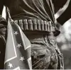  ?? Getty Images file photo ?? A man with ammunition and a Confederat­e flag takes part in a far-right militia rally in Georgia last August.