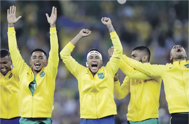  ?? ANDRE PENNER ?? Brazil’s Neymar, middle, celebrates with teammates during the medal ceremony after beating Germany on a penalty shootout for the soccer gold.
